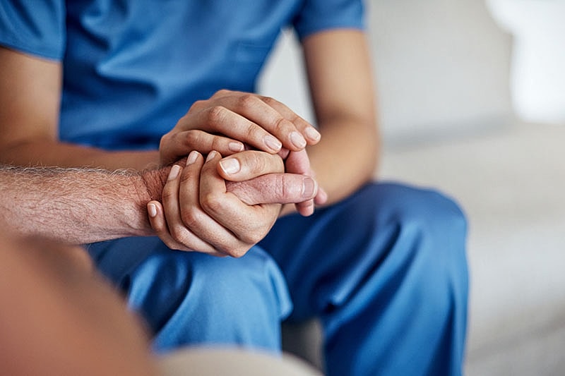 Hands holding in a supportive gesture.
